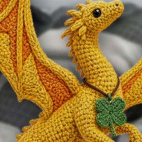 The original golden crochet dragon Lucky with its green clover necklace